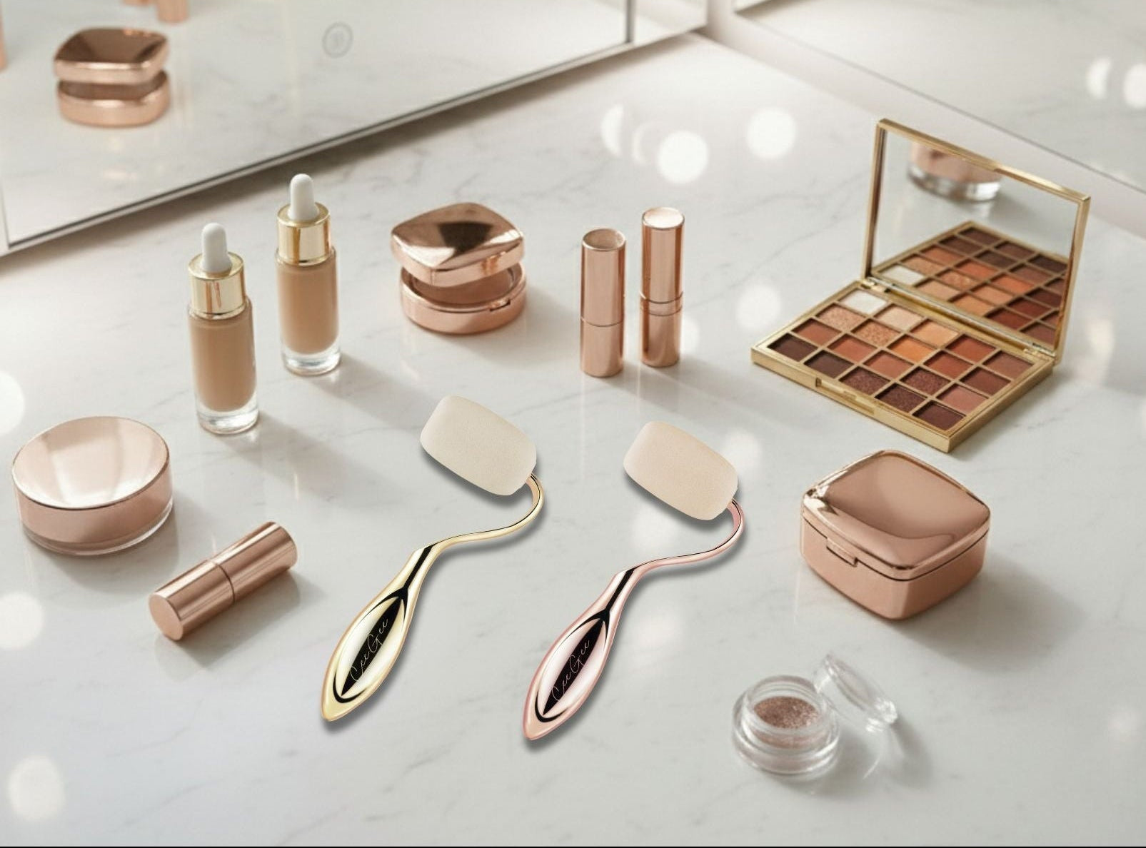 Makeup products including bottles, brushes, and palettes on a reflective surface with a mirror in the background.