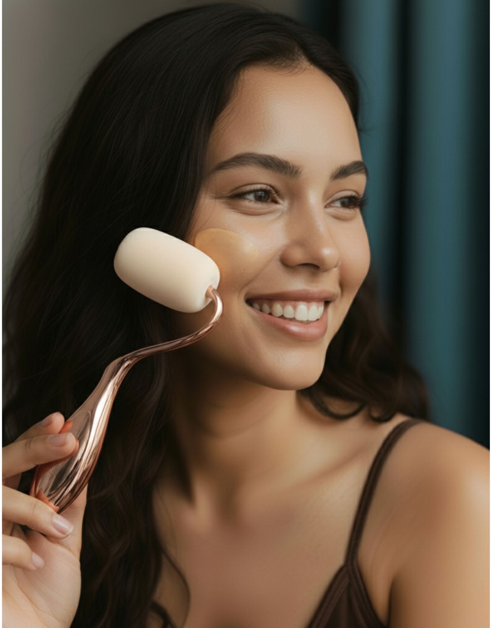 Woman using a rolli sponge on her face with a blurred background